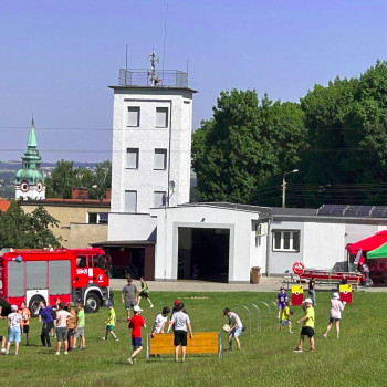 Zdjęcie ogólne pikniku e tle budynek i wóz strażacki